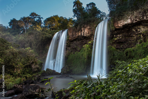 twin water drops in Cataratas del Iguaz   National Park  called Sister junps  Salto dos hermanas  between the jungle forest in Iguaz    Misiones  Argentina with a rainbow. 