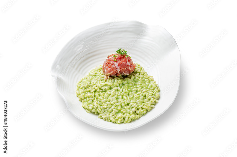 Risotto arborio rice with salmon and spinach in a plate on a white isolated background Risotto arborio rice with salmon and spinach in a plate on a white isolated background
