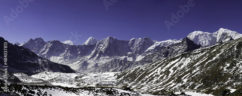 Panorama of mountains and snow in the Himalayas trekking along Everest Circuit in Nepal. © Tristan Barrington
