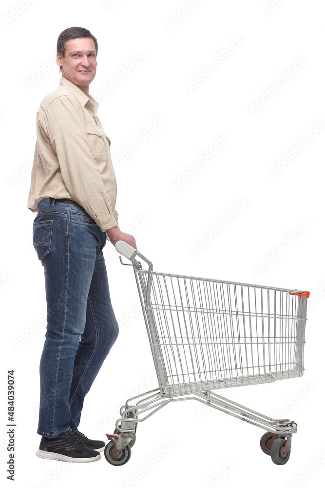 A full length side view portrait of a man pushing an empty shopping cart A full length side view portrait of a man pushing an empty shopping cart