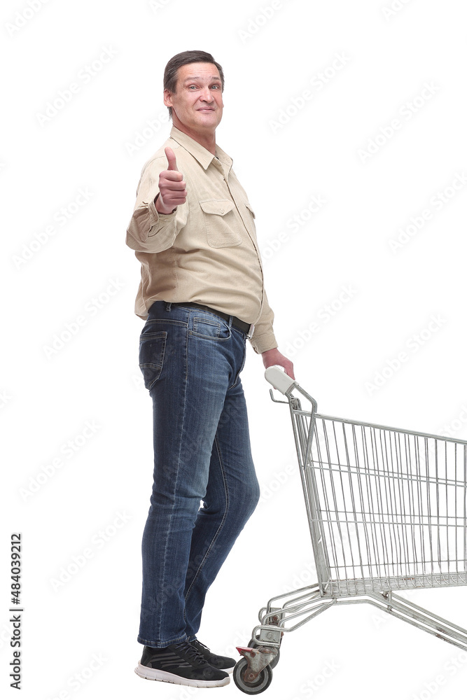 Side view of man with an empty shopping cart making a thumb up gesture Side view of man with an empty shopping cart making a thumb up gesture