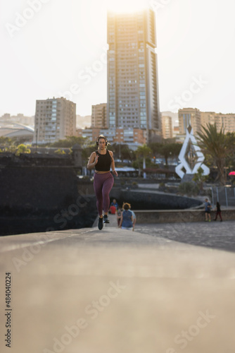 young woman exercising in urban place