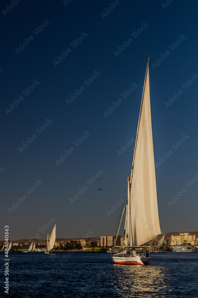 Fototapeta premium Felucca sail boats at the river Nile in Aswan, Egypt