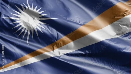 Marshall Islands flag slow waving on the wind loop. Marshall Islands banner smoothly swaying on the breeze. Full filling background. 20 seconds loop. photo