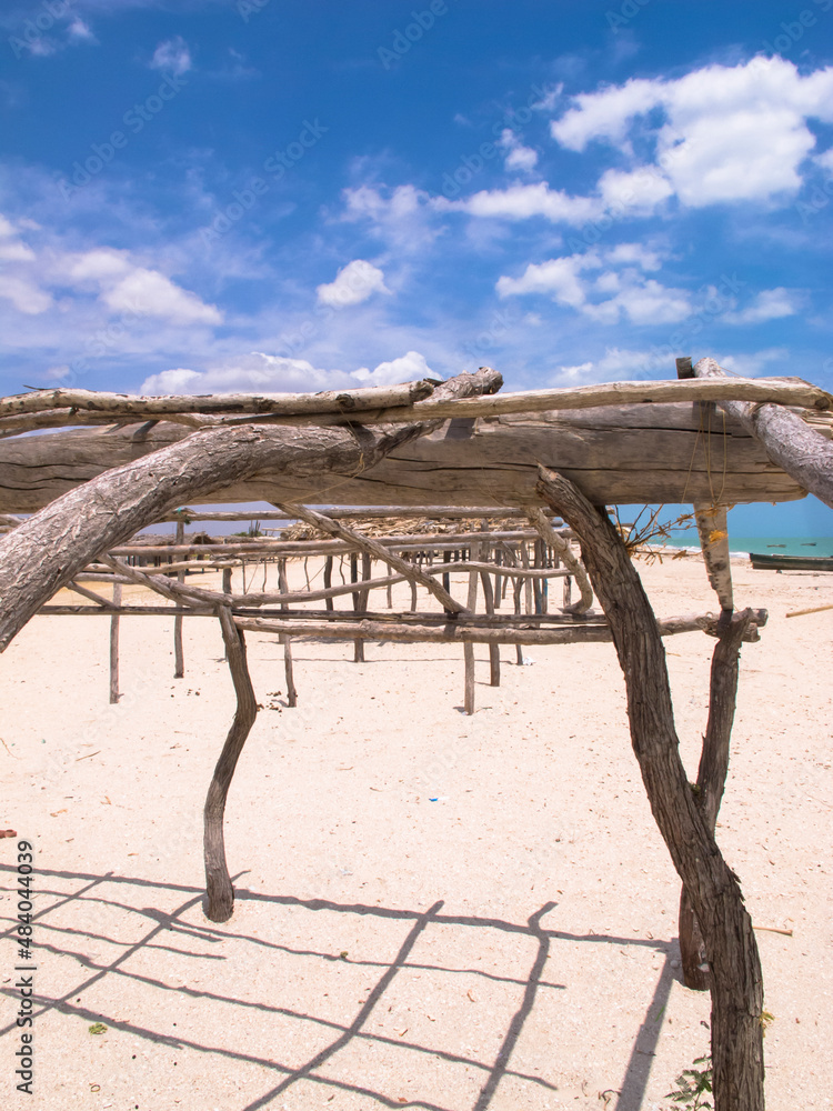 Structures with wooden logs on the beach. Guajira, Colombia. 