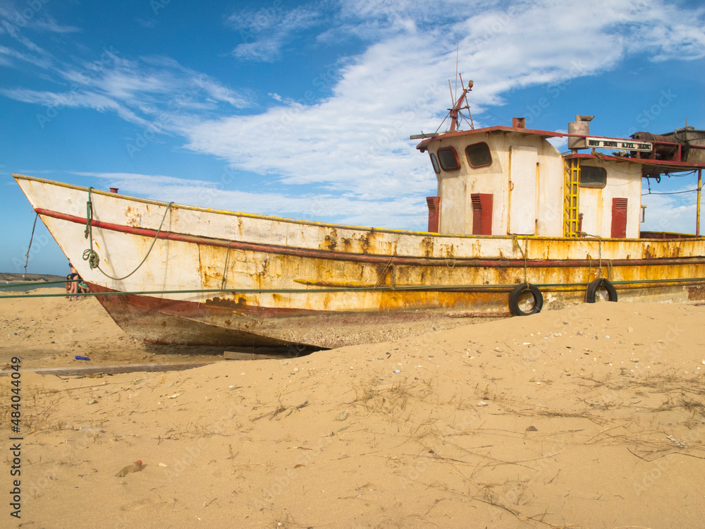 Abandoned boat on the shore of the beach. Guajira, Colombia. Abandoned boat on the shore of the beach. Guajira, Colombia.