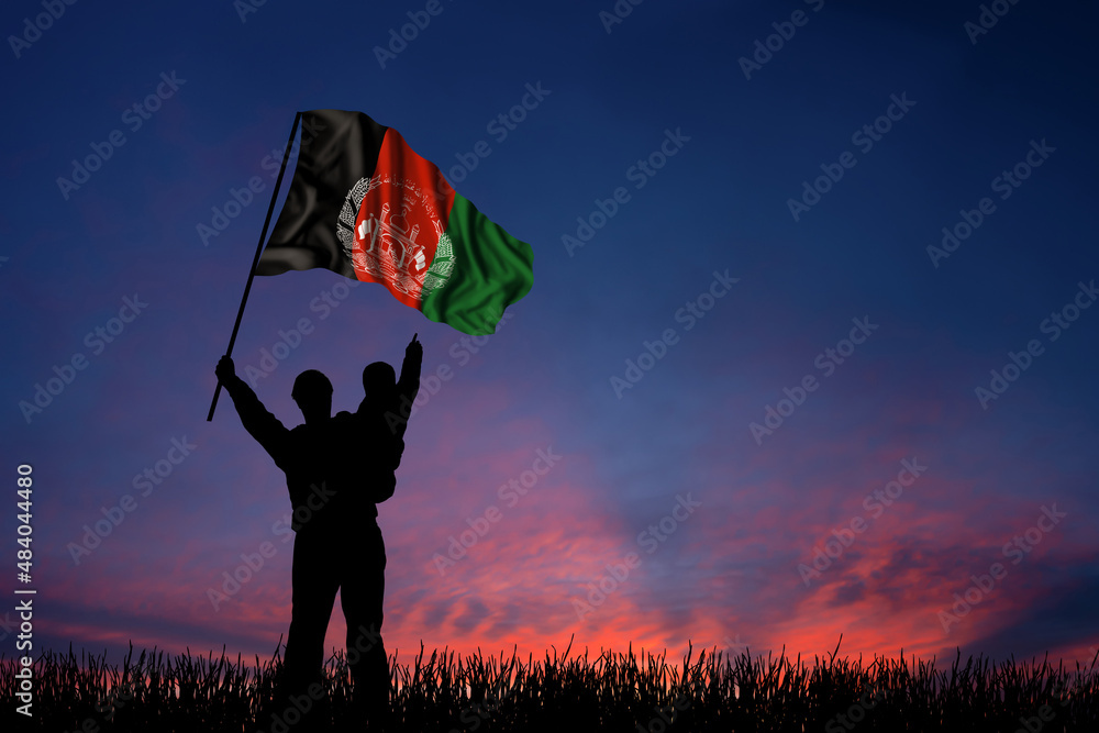 Father and son hold the flag of Afghanistan