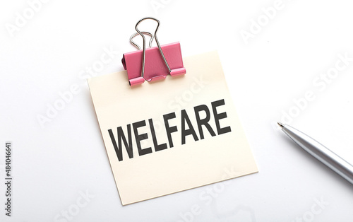 WELFARE text on sticker with pen on the white background