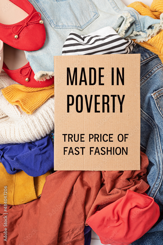 Fast fashion background with pile of cheap, low quality clothes