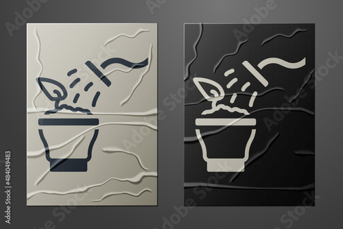 White Spraying a house plant with a spray gun icon isolated on crumpled paper background. Moistening of foliage. Care for home flowers. Paper art style. Vector