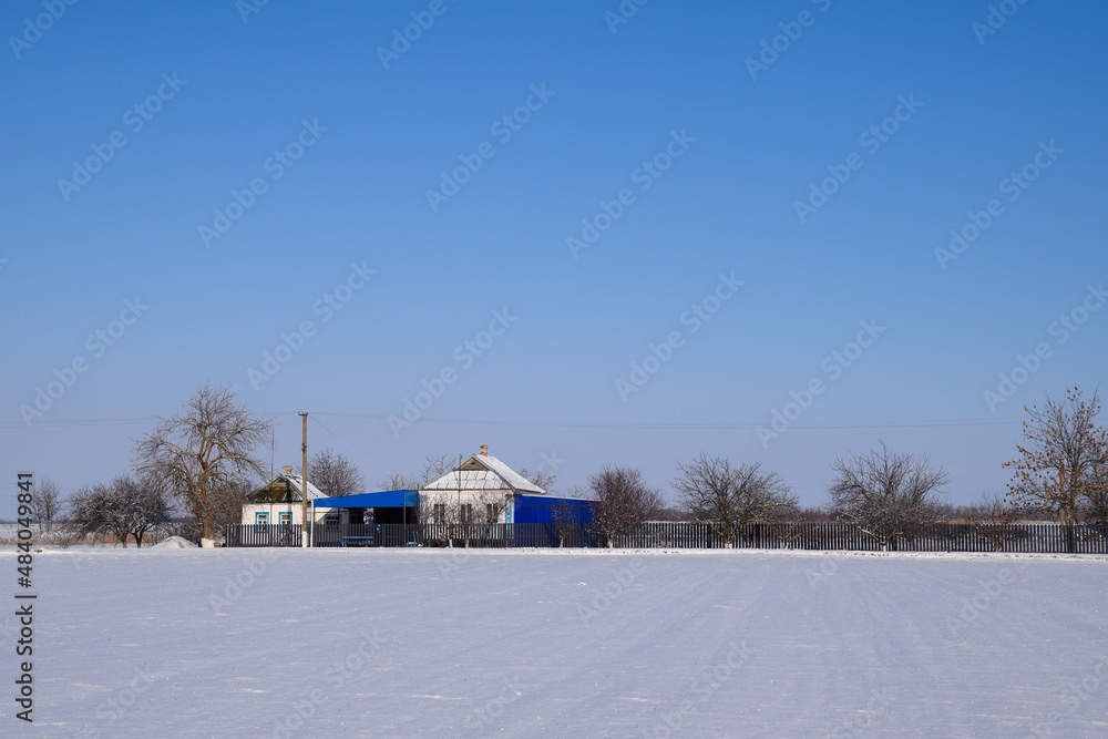 Village house in a Russian village in winter. house is in the snow. Village house in a Russian village in winter. house is in the snow.
