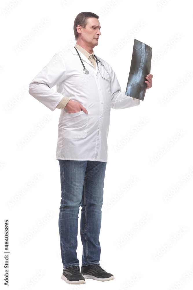 Attractive doctor examining an x-ray and looking at the camera Attractive doctor examining an x-ray and looking at the camera