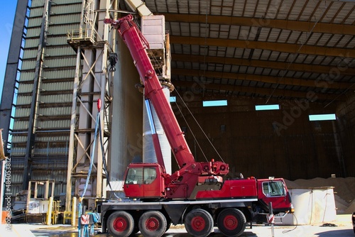 Red crane on industrial construction site
