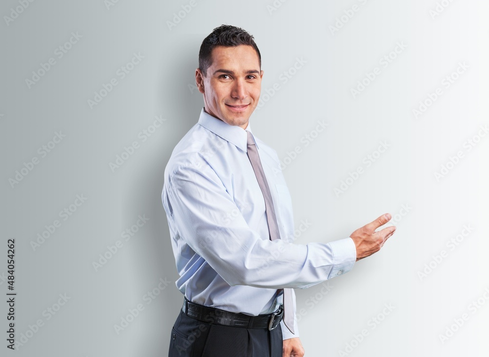 Portrait of attractive glad cheerful man demonstrating ad copy space Portrait of attractive glad cheerful man demonstrating ad copy space