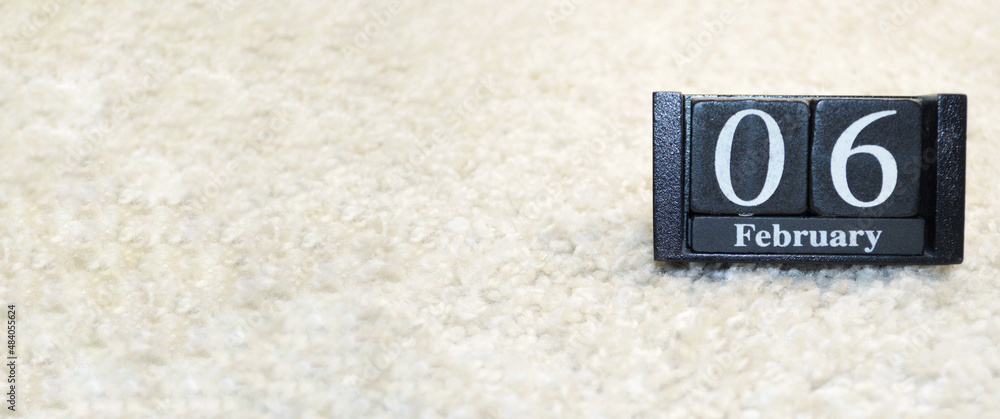 Wooden calendar from blocks on white background with copy space. 6th of February