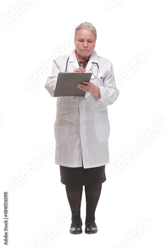 Happy mature doctor with stethoscope writing on clipboard, isolated