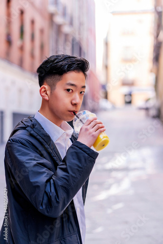 Asian drinking a delicious healthy juice photo