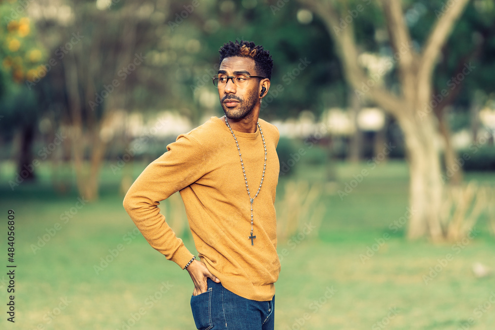 portrait of a man turning his head while wearing small headphones portrait of a man turning his head while wearing small headphones