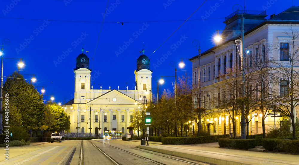 Nightlife of illuminated central Debrecen streets with Great Protestant Church, Hungary