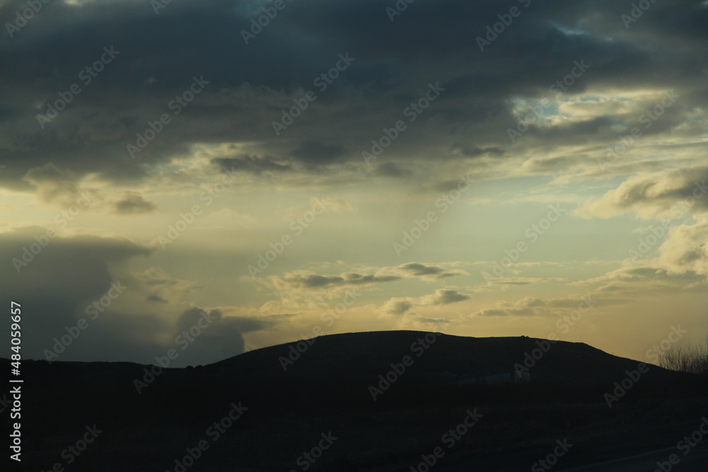 gloomy sunset on the background of the hill gloomy sunset on the background of the hill