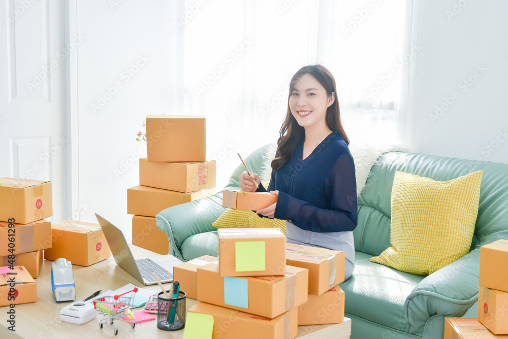 Female startup small business owner working with notebook computer at home. Online selling. E-commerce. Female startup small business owner working with notebook computer at home. Online selling. E-commerce.