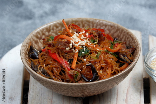 Korean authentic cuisine, Japchae or glass noodles stir fried with vegetables photo
