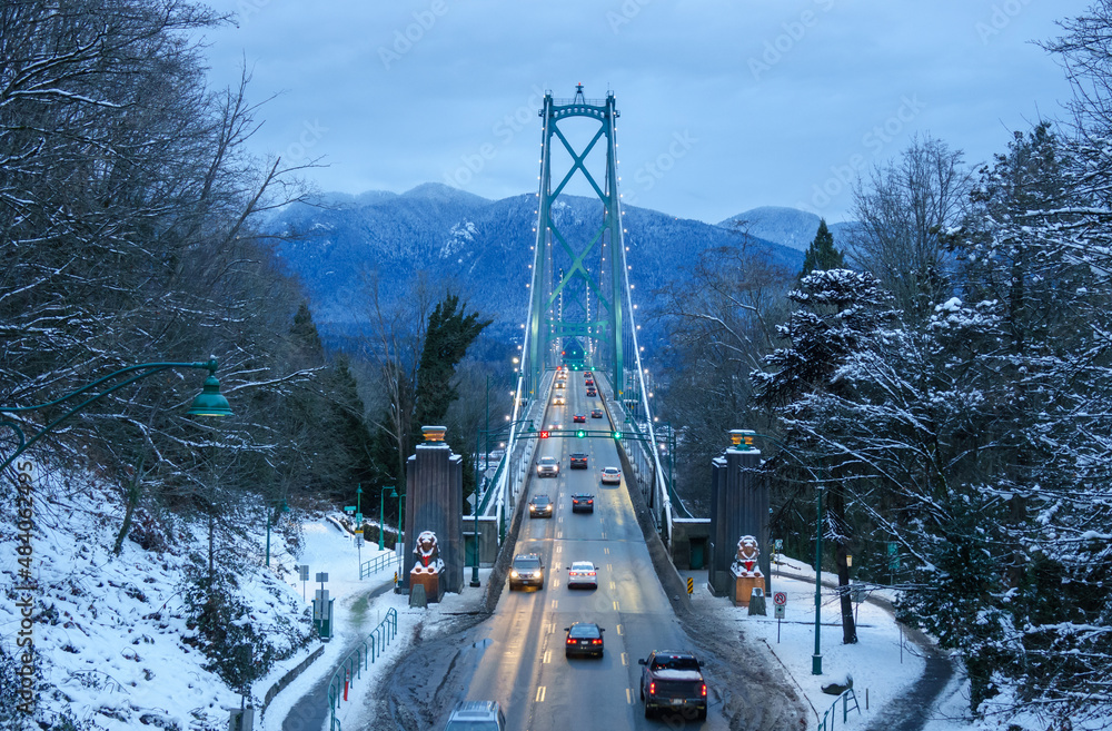 Naklejka premium View of Lions Gate suspension Bridge in Vancouver, British Columbia, Canada at night in winter full of lights