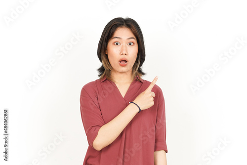 Showing and Pointing Product With Forefinger Of Beautiful Asian Woman Isolated On White Background