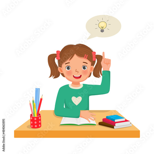 Little girl got an idea to solve the problems in math homework raised her finger pointing up while sitting studying on the desk at home