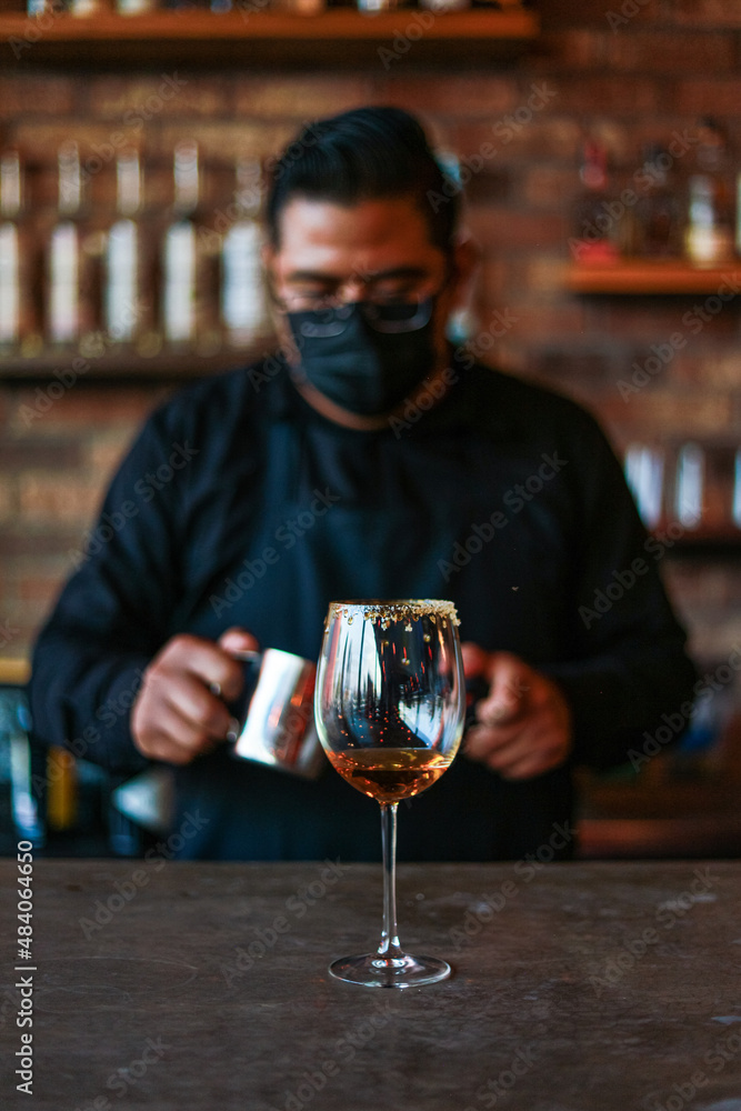 Bartender preparing a drink on a glass Bartender preparing a drink on a glass