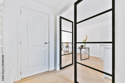 Fotografi Stylish corridor with a large glass door with a black frame