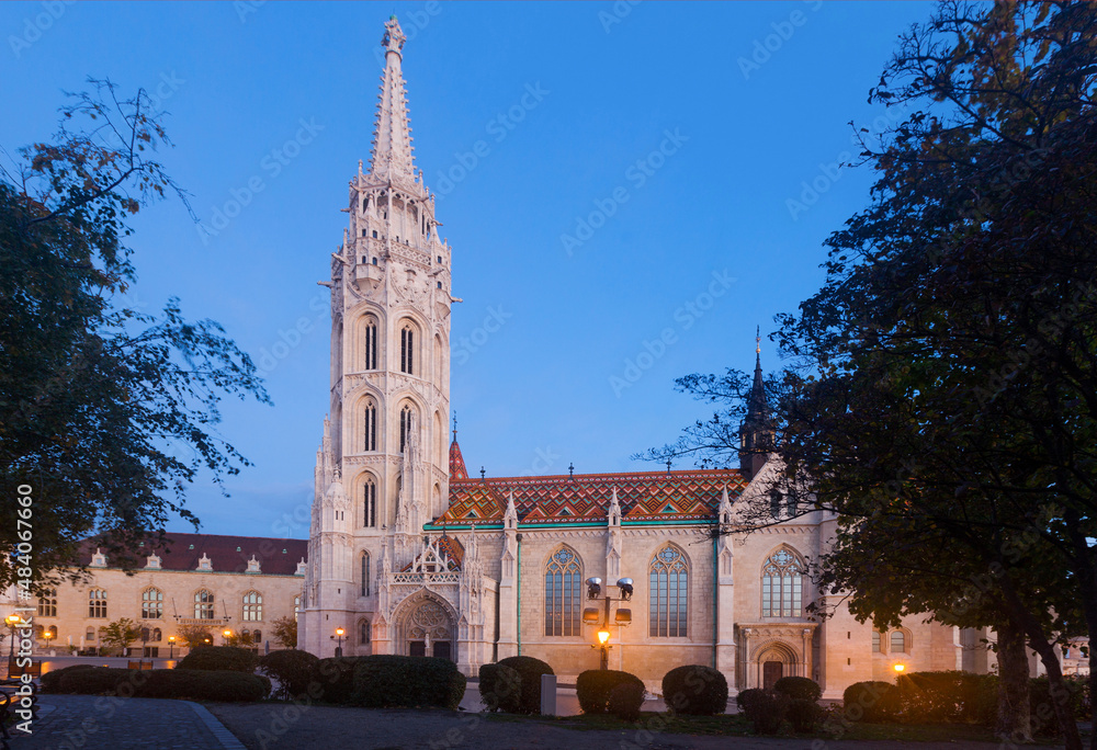 Lush Gothic architecture of Matthias Church on Buda hill in twilight, Hungary.