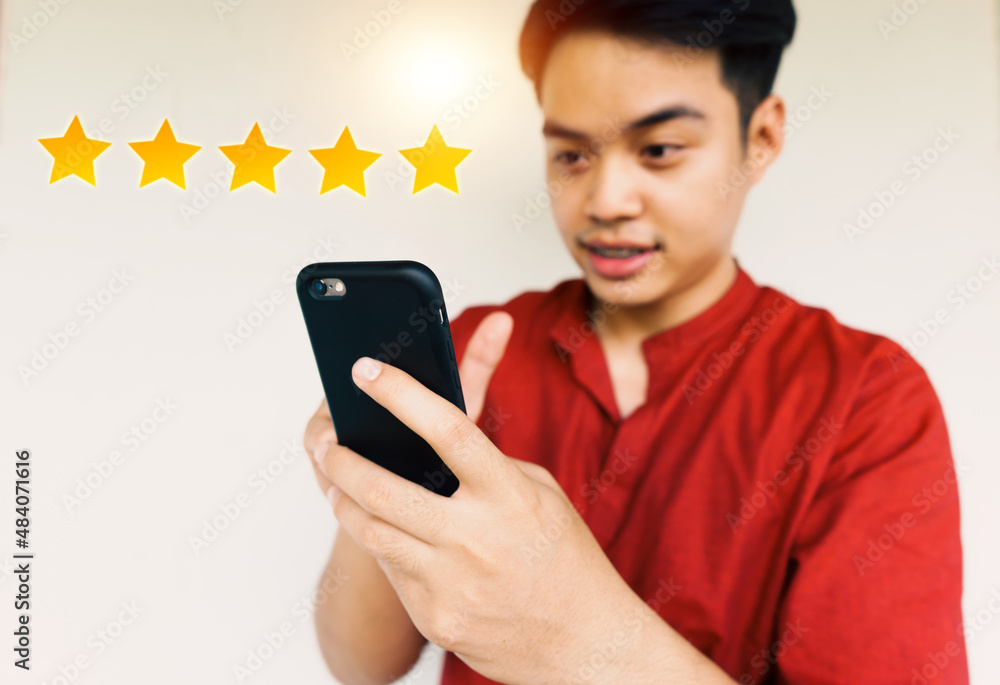 man smiling and using mobile phone for giving five stars, customers services and satisfaction, rating rak and giving feedback, best rank