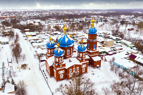 Aerial view of snow covered Petrovsk cityscape with Church of Intercession of Holy Virgin in winter, Saratov region, Russia. photo