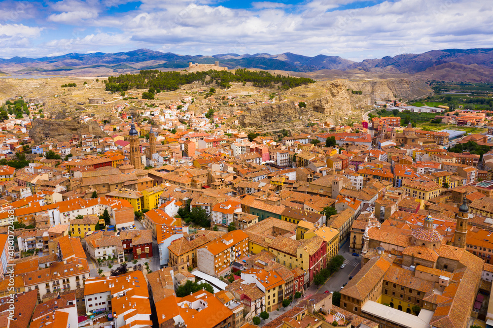 View from drone of Spanish town of Calatayud on background of impressive mountain landscape of Iberian System in summer day..