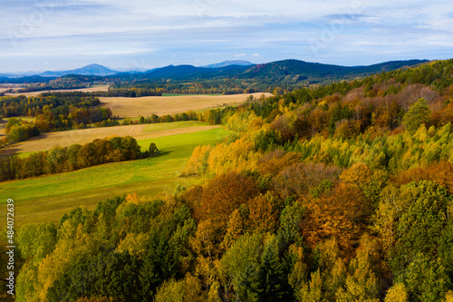Aerial view of picturesque autumn hilly landscape with colored trees..
