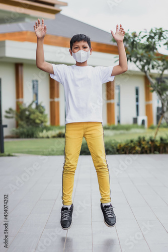 Happy hipster kid wearing plain white t-shirt and protective mask for t-shirt mock up