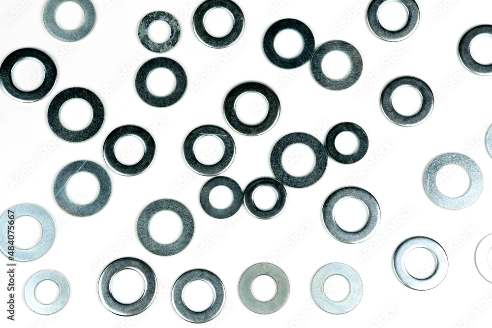 several silver metal washers on a white background. close-up