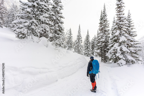 tourist with a backpack in the winter forest © Kate Prosvirnina