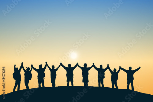 Silhouette group of people on top the mountain. Illustration sunset background. Business, teamwork, goal and success concept.