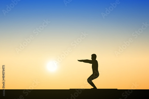 Fototapeta Naklejka Na Ścianę i Meble -  Silhouette of young people doing yoga exercises at sunset background. health concept.
