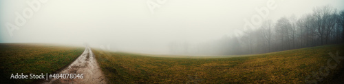 Panorama of an autumn field on a cold foggy morning