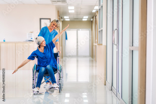 Professional medical doctor team with stethoscope in uniform discussing with patient woman with cancer cover head with headscarf of chemotherapy cancer in hospital.health care concept