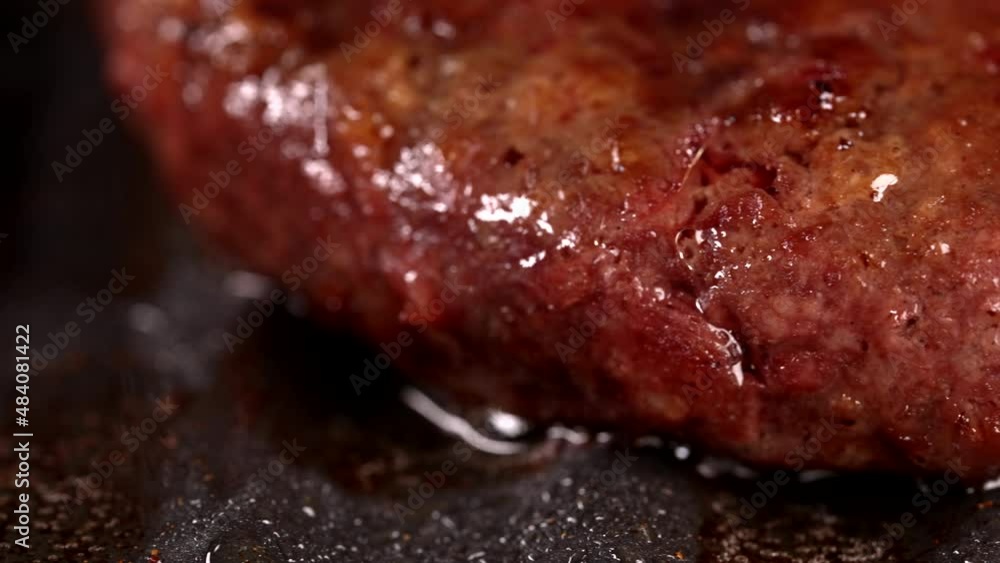 Process of roasting meat steak on barbecue grill plate. Cooking beef or pork patty. Raw cutlet for burger. Close-up dolly shot. Process of roasting meat steak on barbecue grill plate. Cooking beef or pork patty. Raw cutlet for burger. Close-up dolly shot.