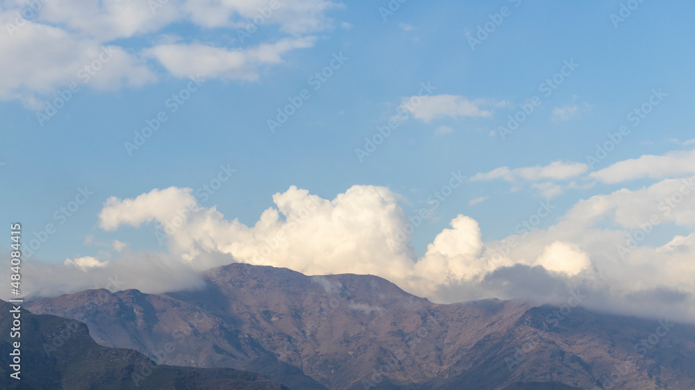 Scenery view of mountains with clouds and blue sky