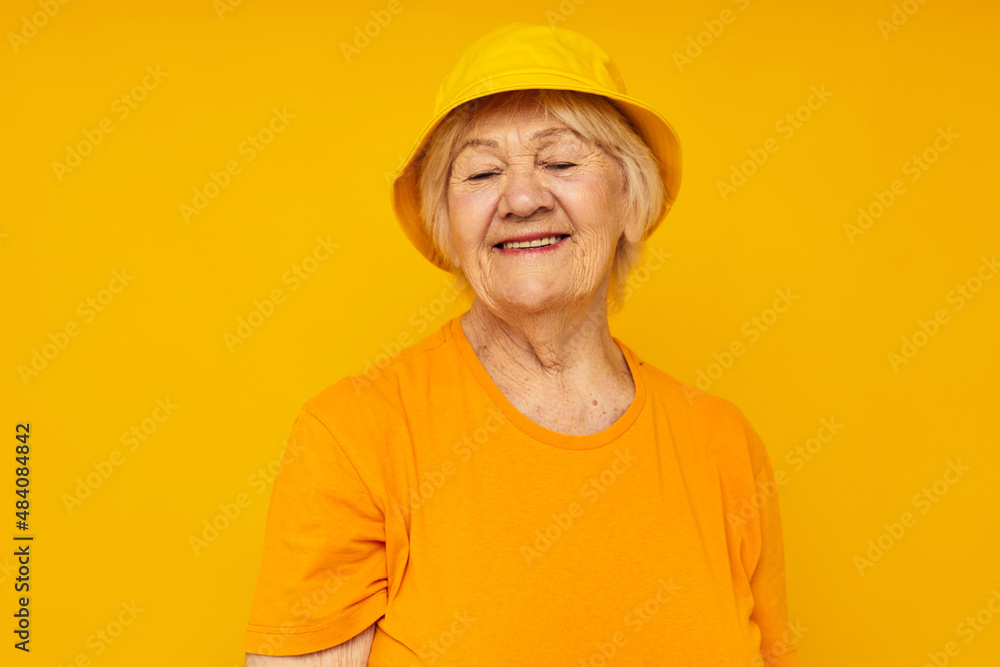 smiling elderly woman happy lifestyle in a yellow headdress yellow background smiling elderly woman happy lifestyle in a yellow headdress yellow background