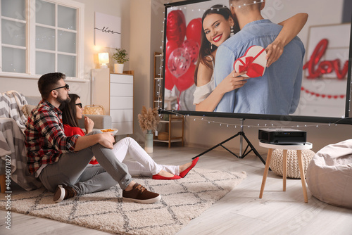 Bild auf Leinwand Young couple watching romantic movie at home