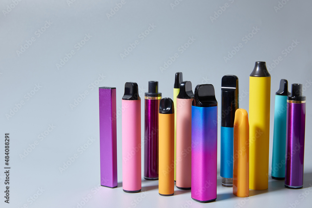 Vape e-cigarettes on a gray background with a place for text or product advertising - obrazy, fototapety, plakaty 