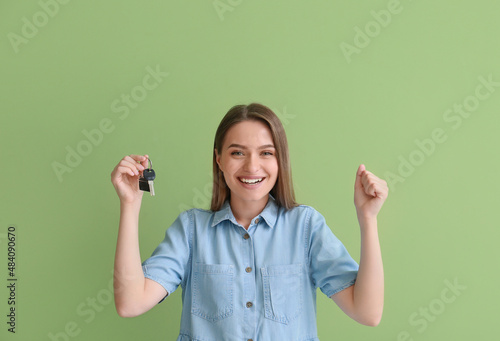 Happy young woman with key ...