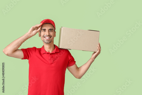 Male courier with parcel on...